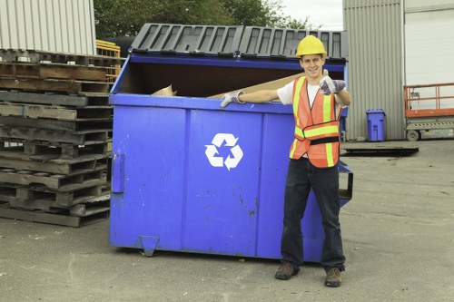 Sustainable rubbish area with labelled bins and recycling signage